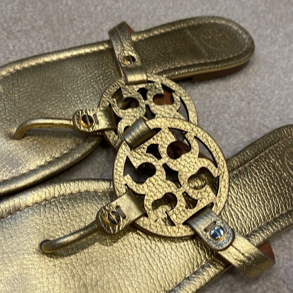 One pair of gold Tory Burch flip flops